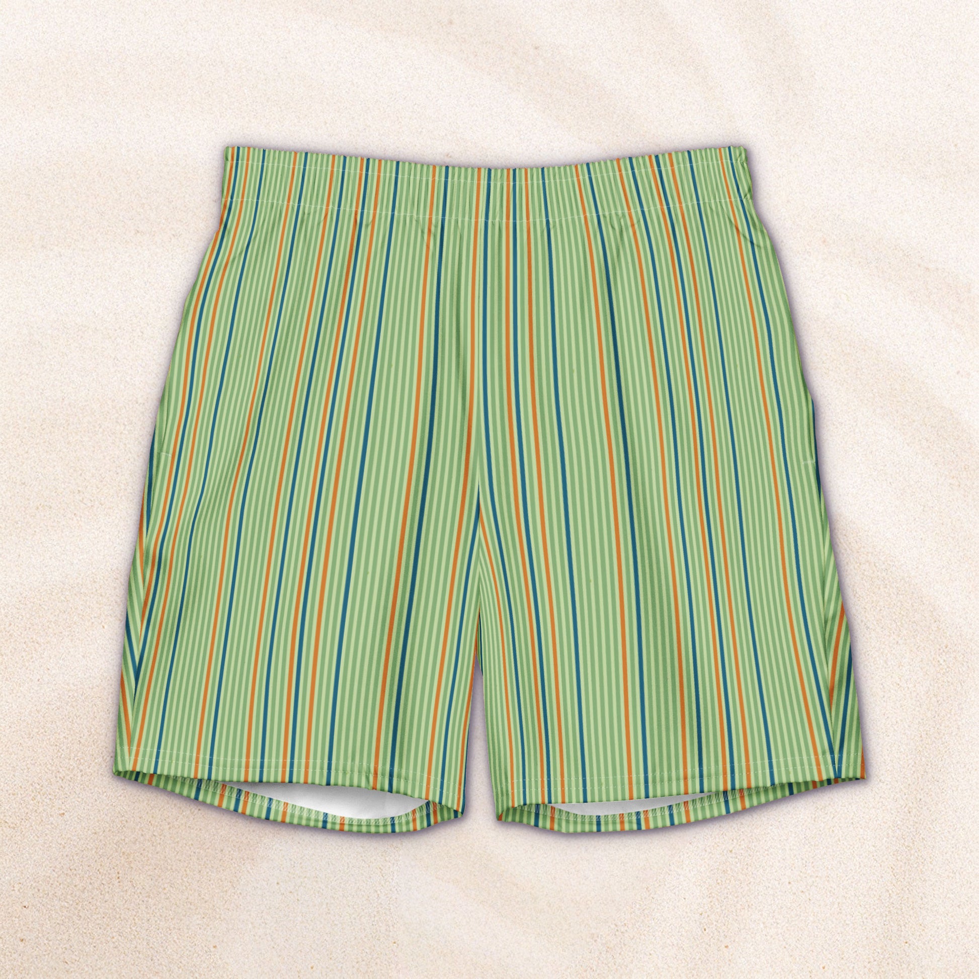 Striped swim trunks with green, orange, and dark teal pattern on a light sage background